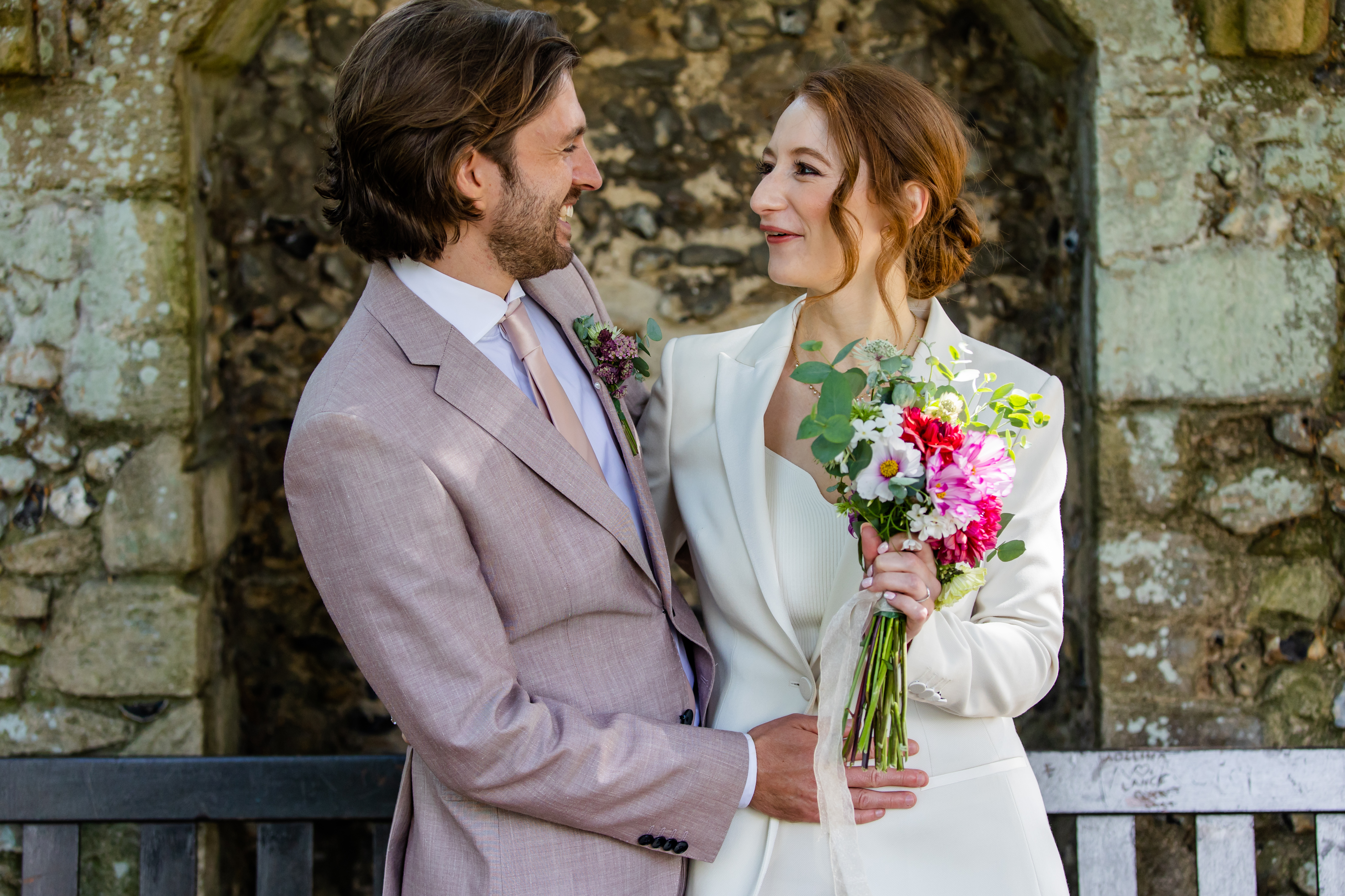 Bride and groom smiling and looking at each other. 