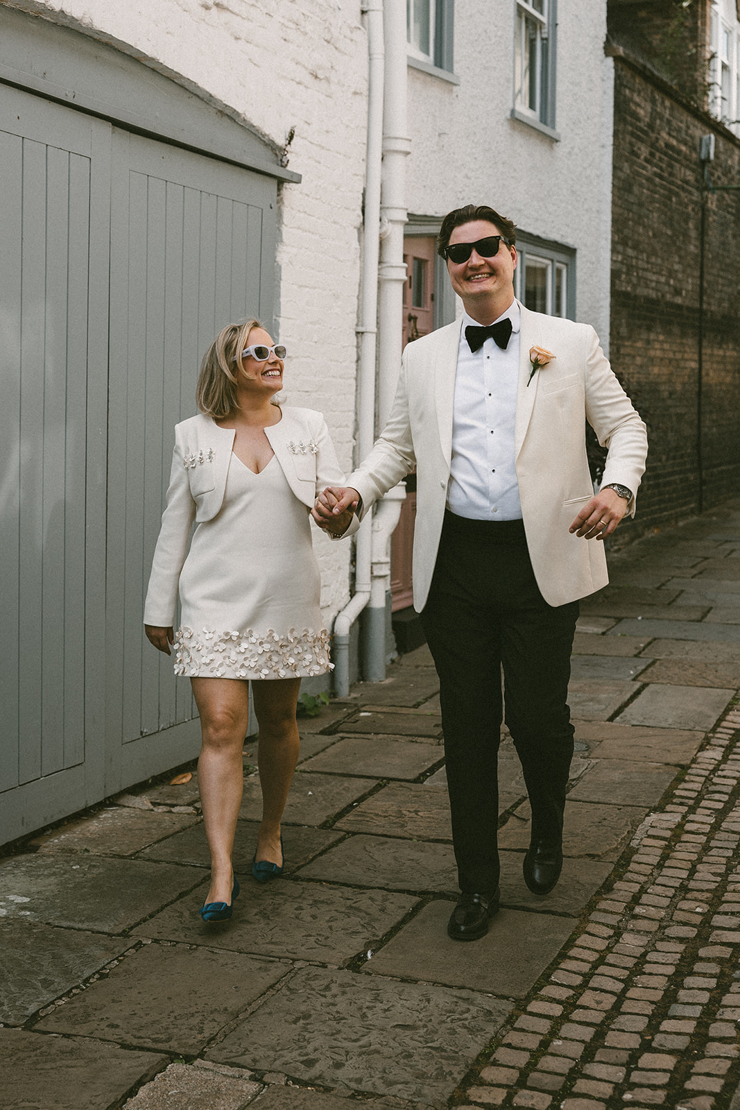 Bride and groom walking along street