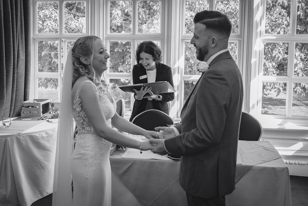 Bride and groom with celebrant at the John Milton Room Stowmarket Register Office