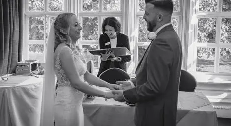 Bride and groom with celebrant at the John Milton Room Stowmarket Register Office