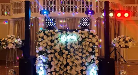 DJ Booth complete with white artificial flowers