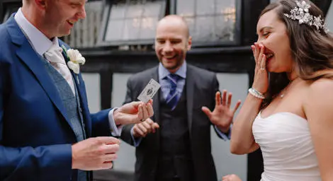 Chris Campos Magician doing card trick with bride and groom