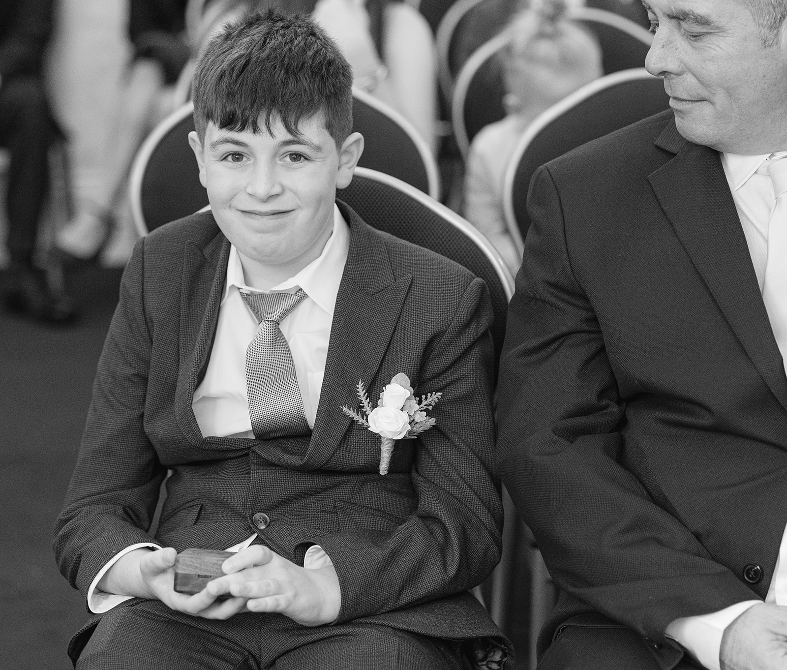 Young boy holding box with wedding rings 