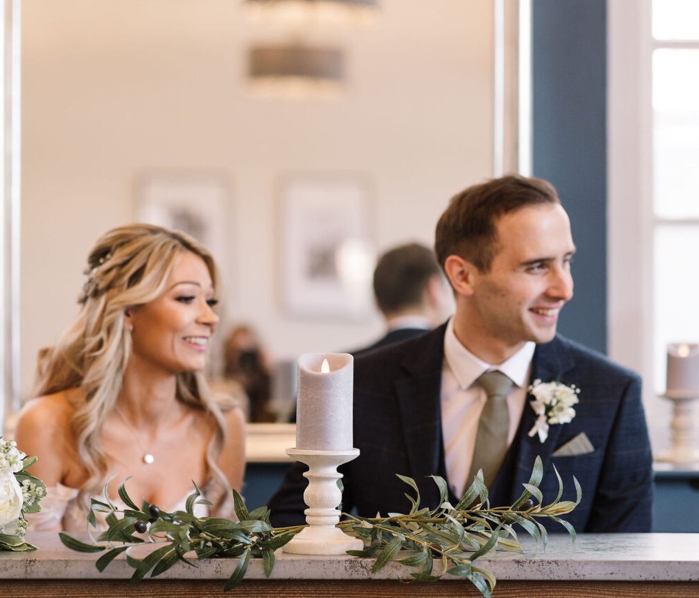 young white couple about to sign their wedding register. 