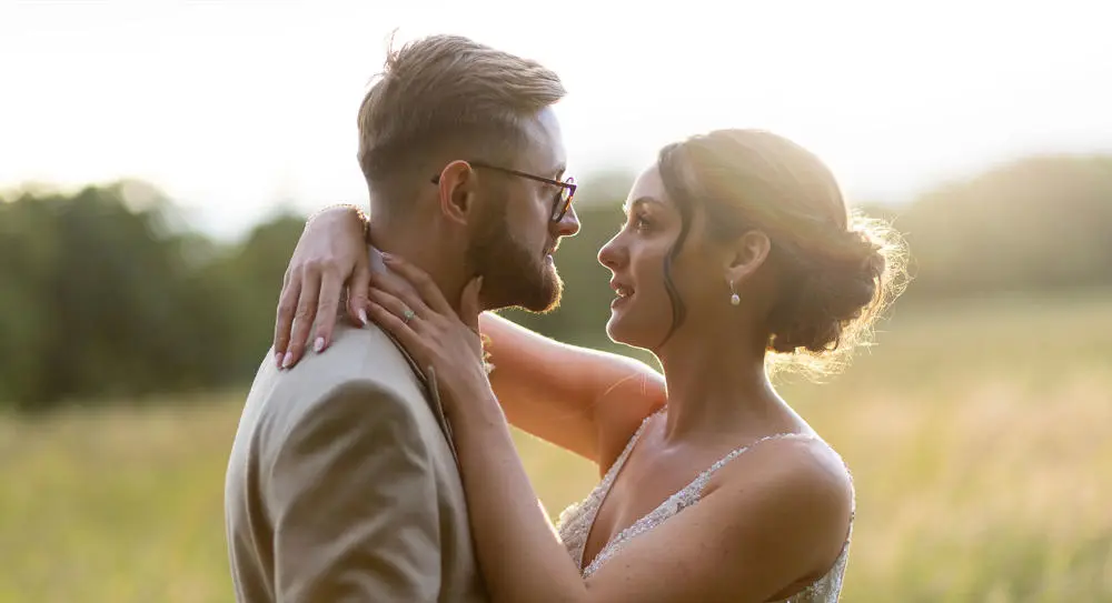 Bride and groom embracing and looking at each other