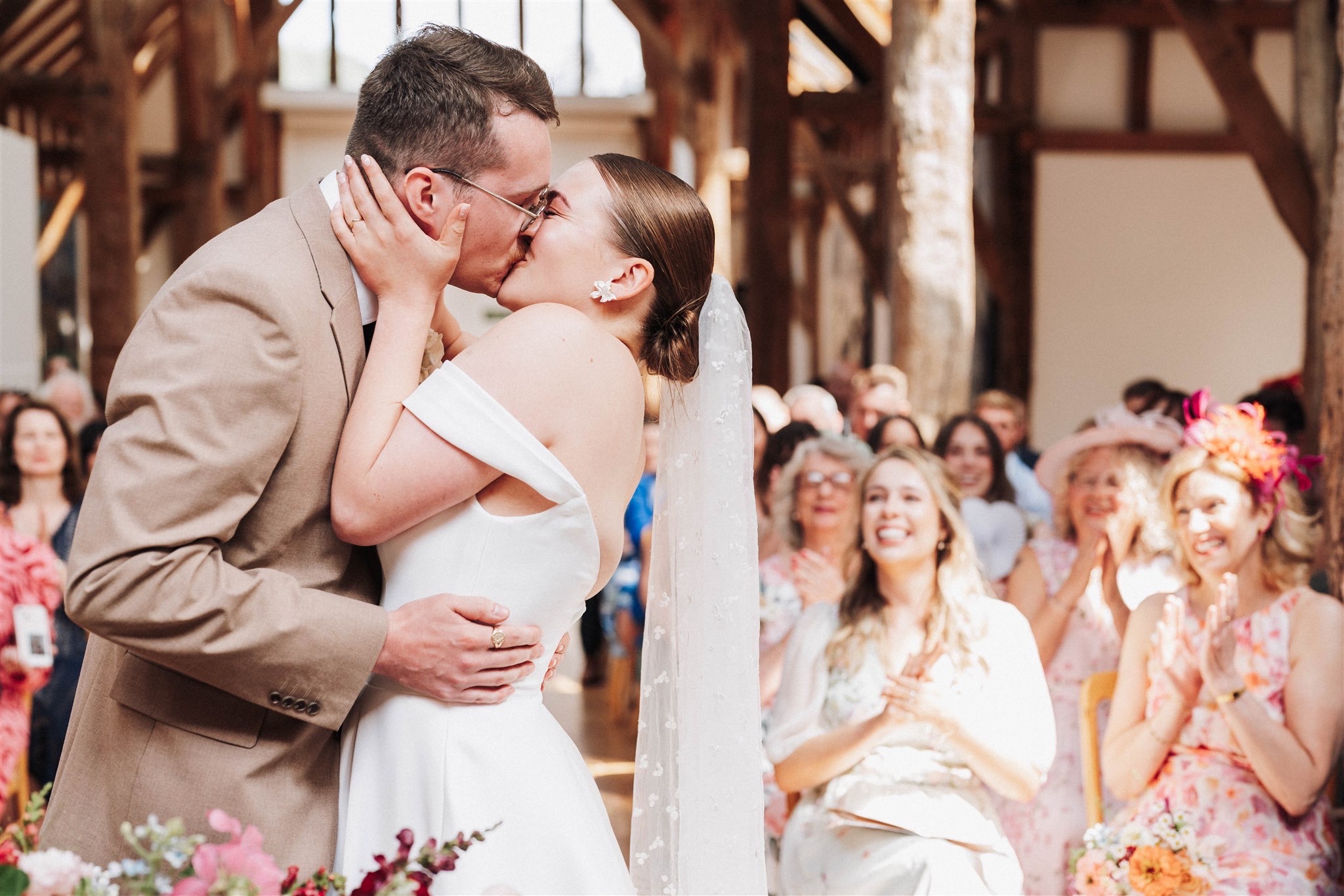 Bride and groom kissing passionately during their ceremony