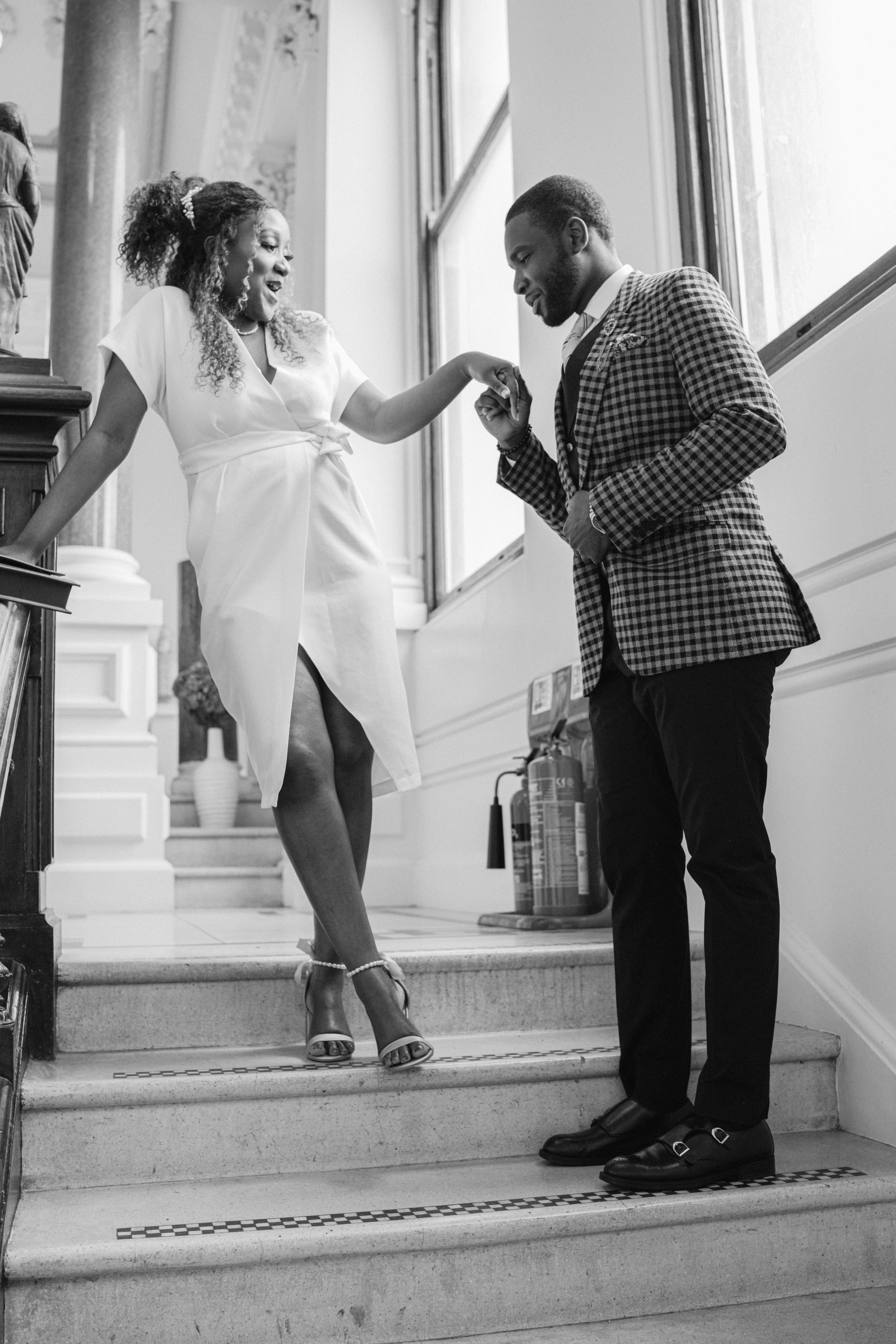Couple on stairs of Ipswich Town Hall to get married at Ipswich Register Office Pickwick Room.