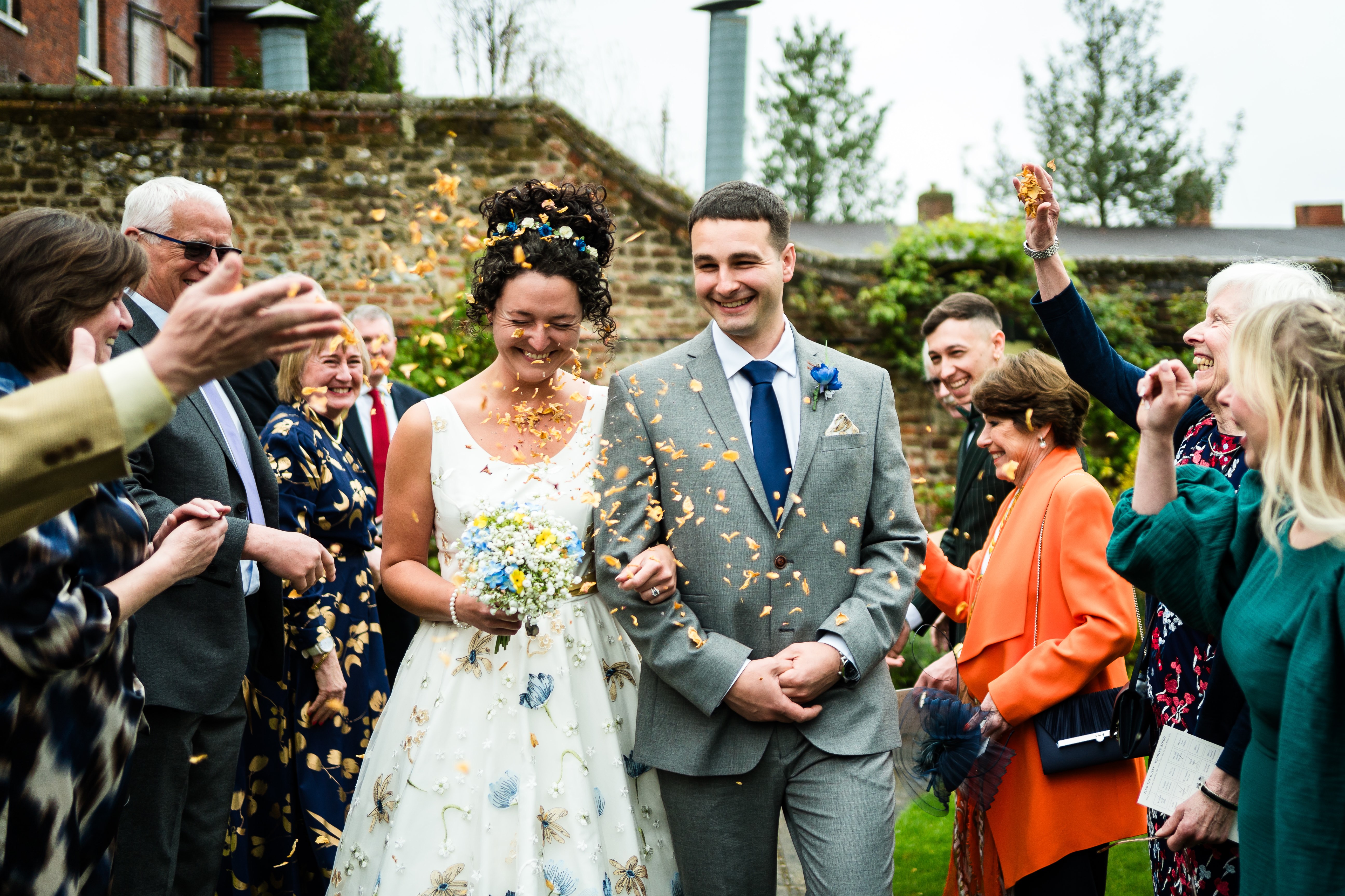 Couple outside walking in confetti shower