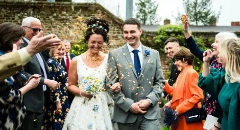 Couple outside walking in confetti shower