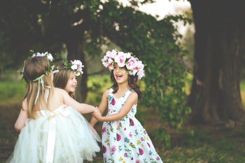 Three girls dancing with flower crowns Little Guest Creche