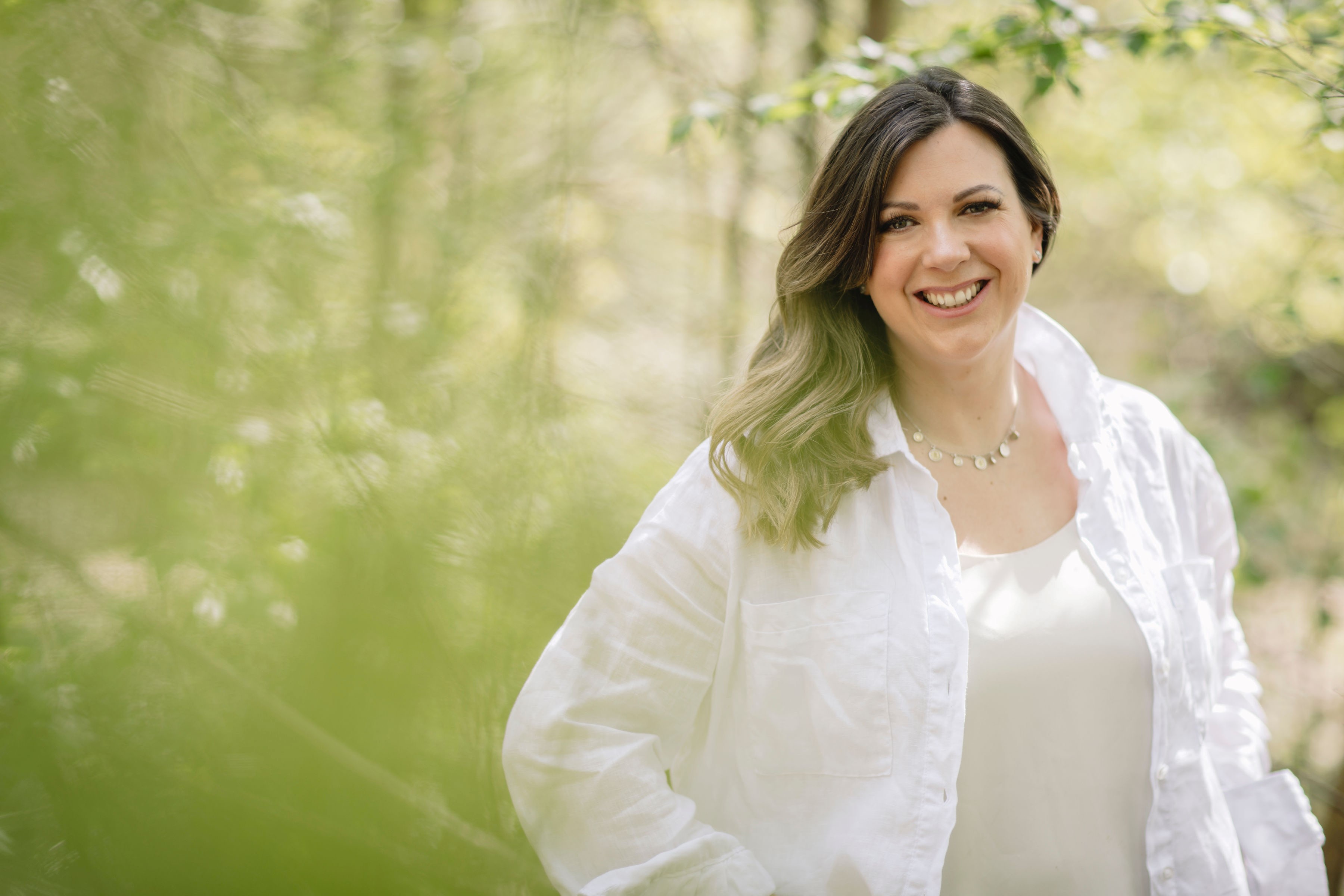 Louisa May Wedding planner smiling in a meadow
