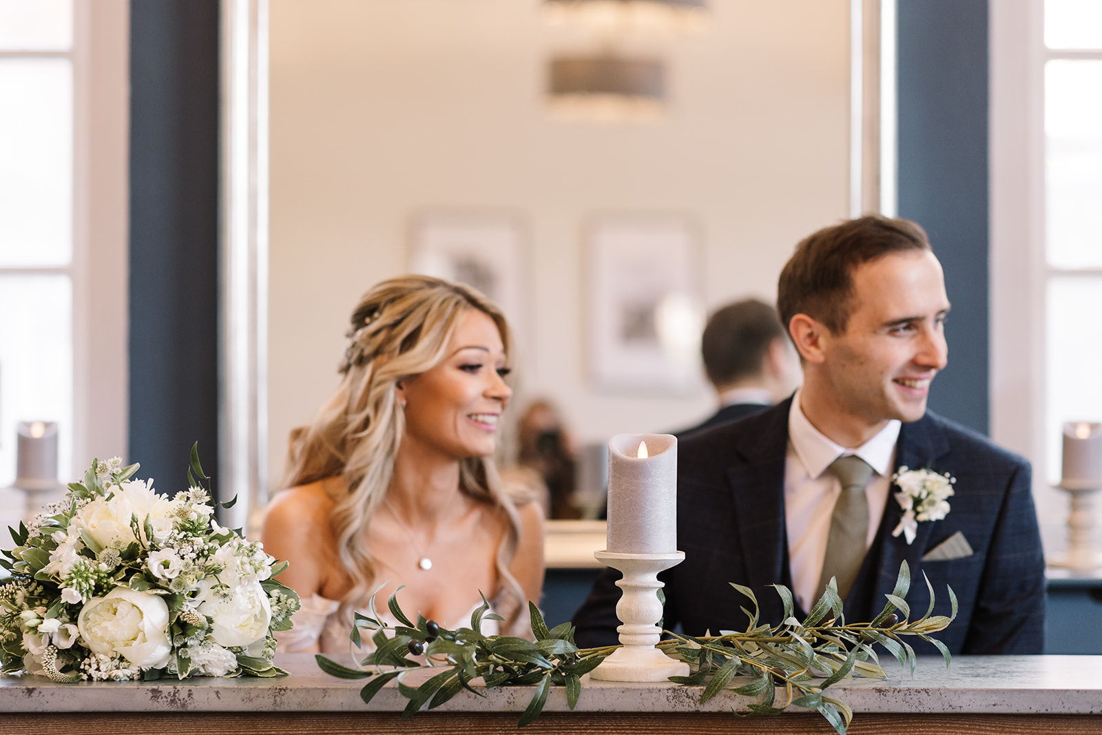 Couple sitting at ceremony table Abbeygate Room