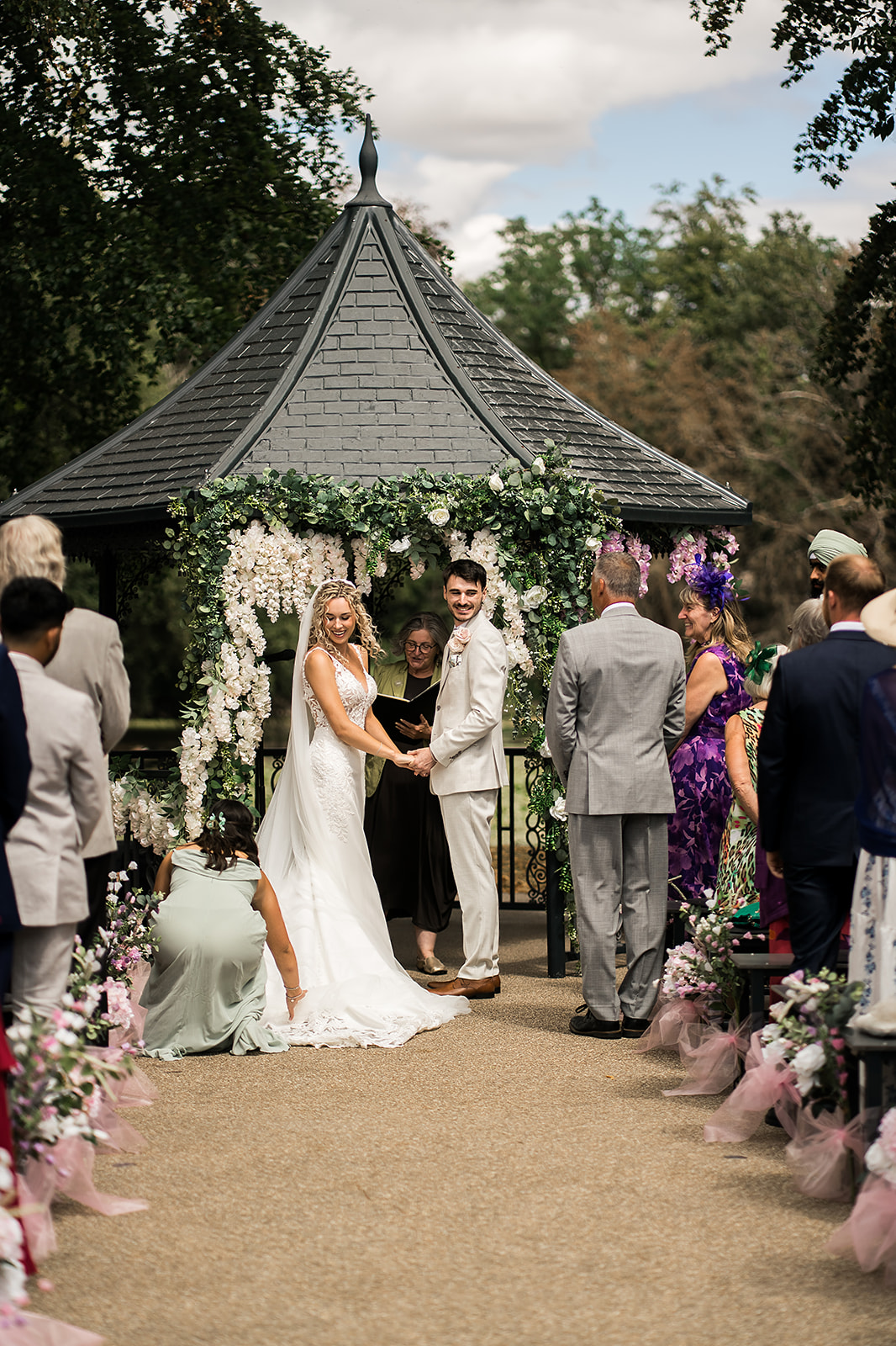 Bride and groom with celebrant at their outdoor wedding