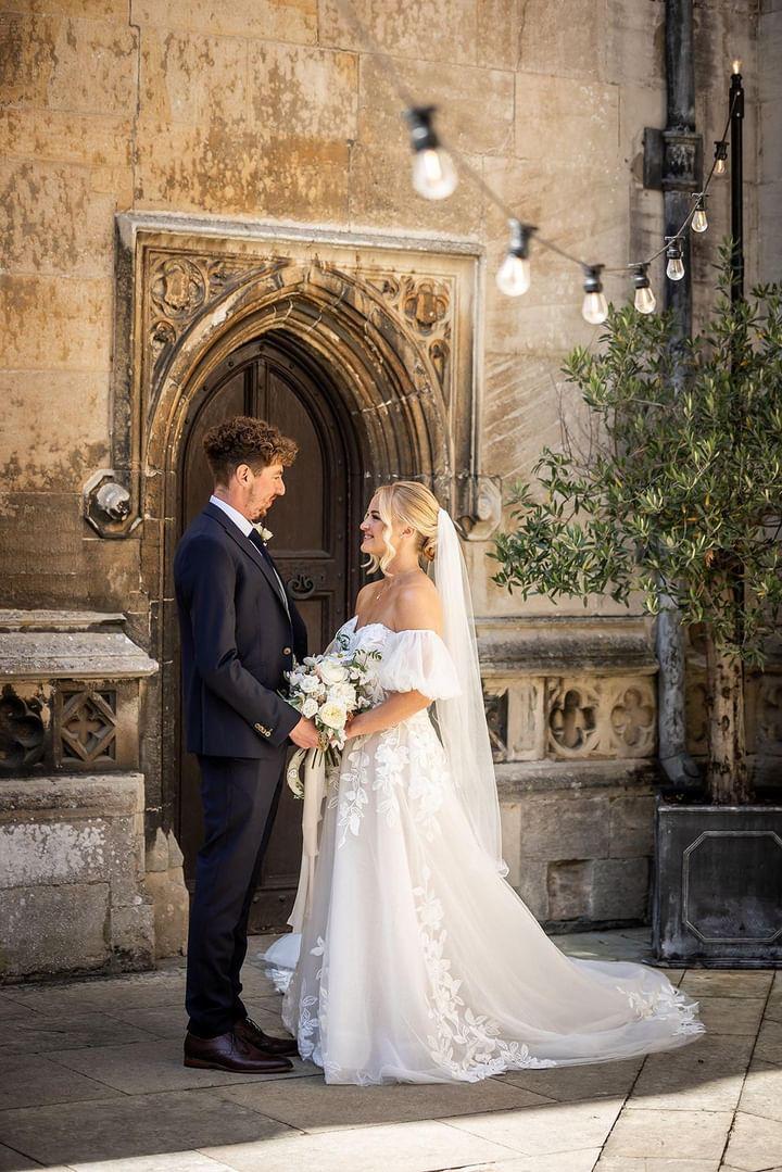 Young wedding couple holding hands and smiling at each other
