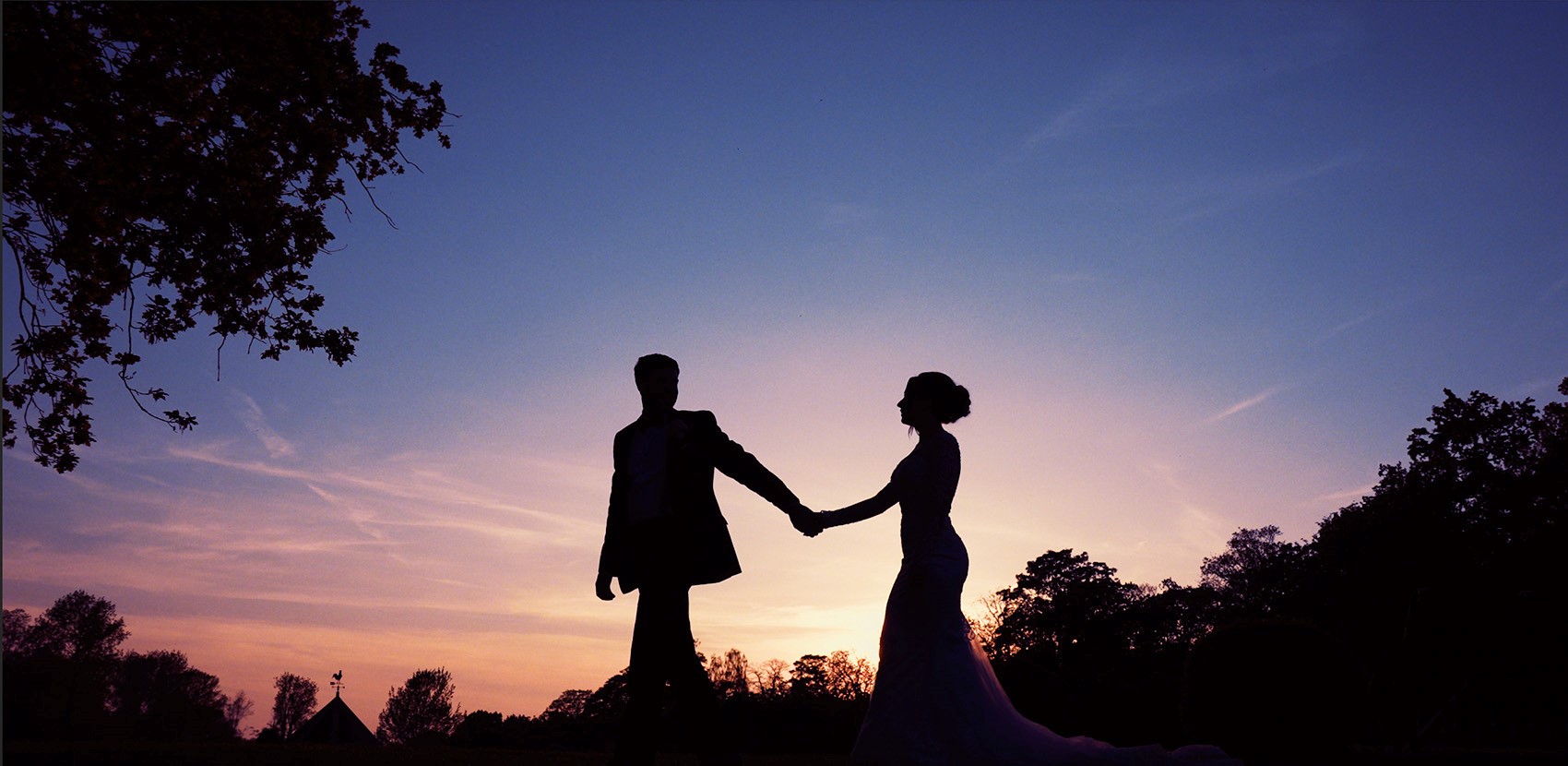 Couple walking together at sunset holding hands