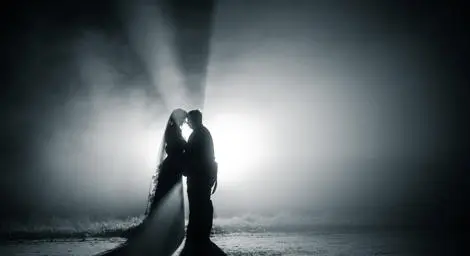 Black and white image of bride and groom dancing