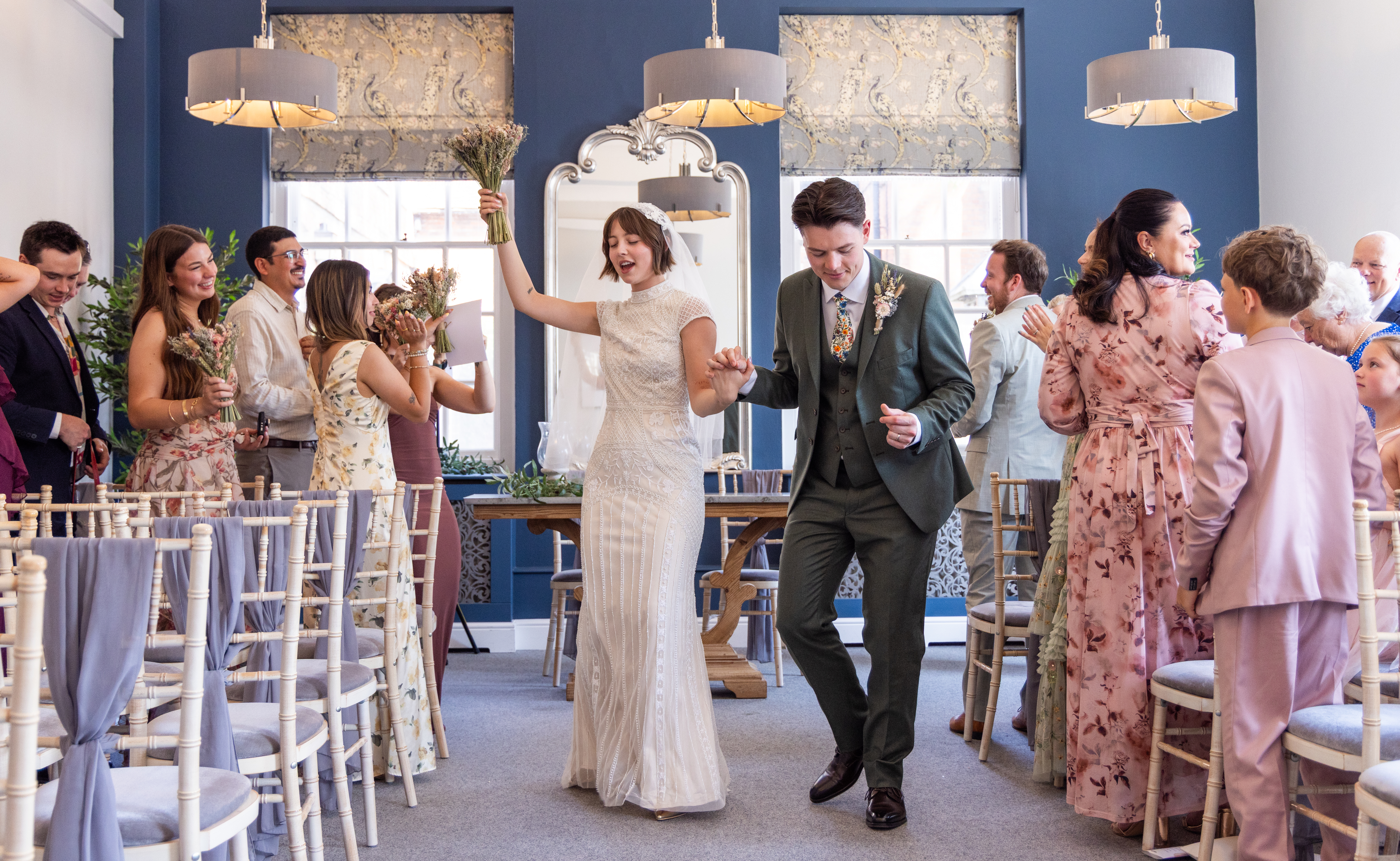 Newly married couple and wedding guests celebrating after a legal civil marriage ceremony