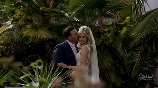 Bride and Groom kissing in exotic garden
