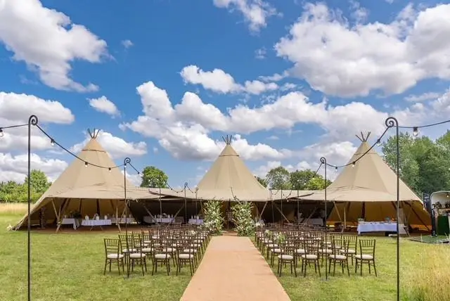 Beautiful tent marquees with chairs and aisle set up for wedding