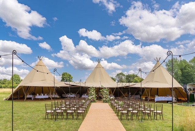 Beautiful marquees with chairs and aisle set up for wedding
