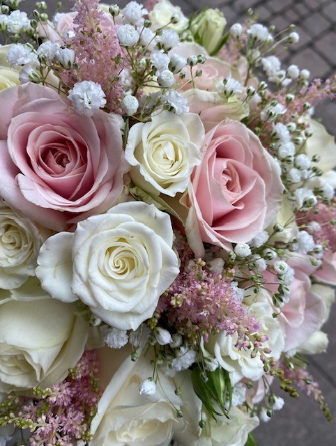 Bridal bouquet pink and white roses with some greenery