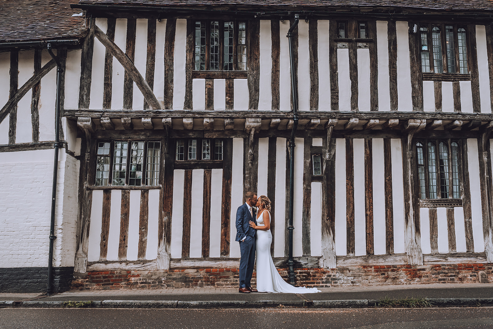 Bride and groom kissing outside the Swan at Lavennham.