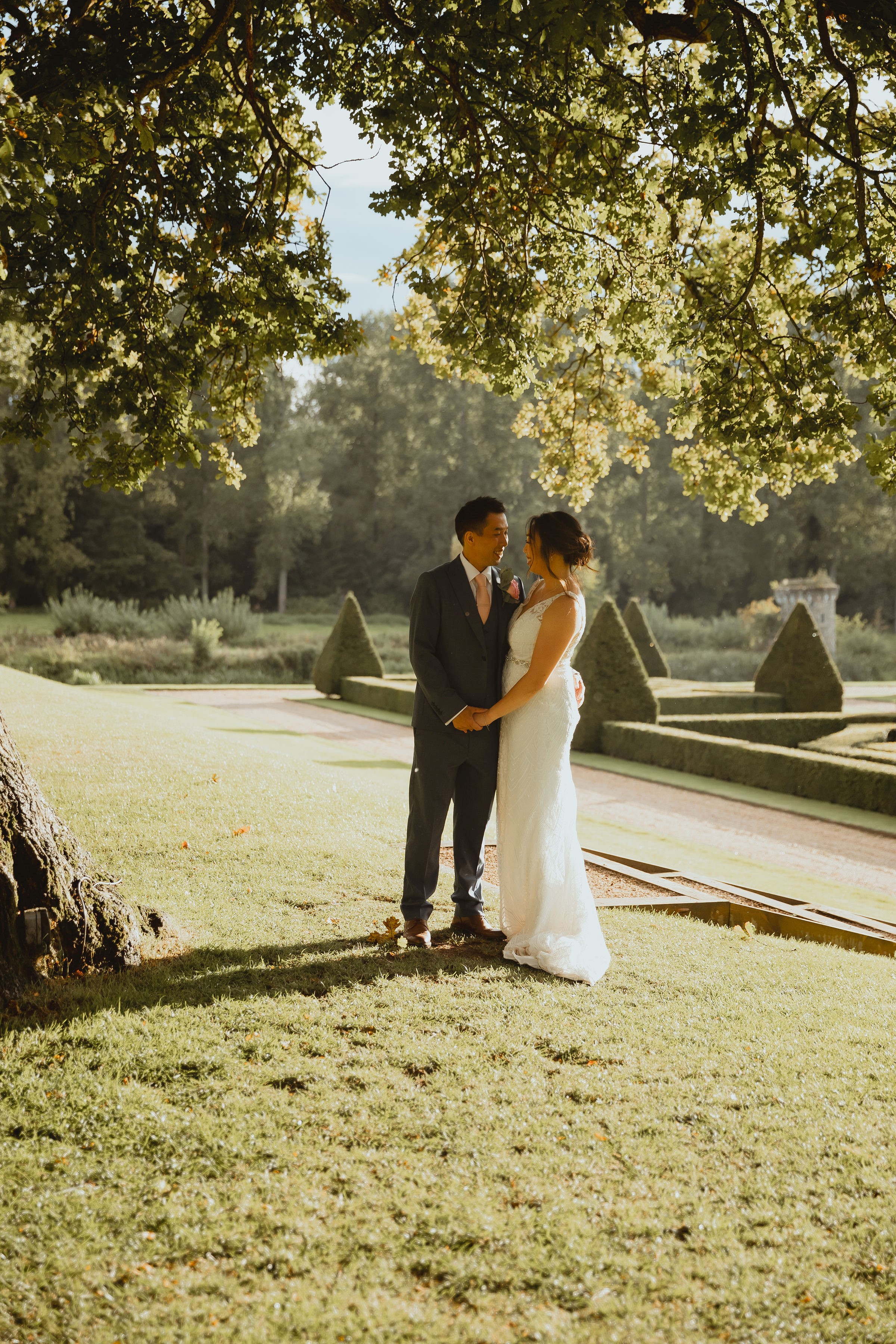 Bride and Groom in park holding hands