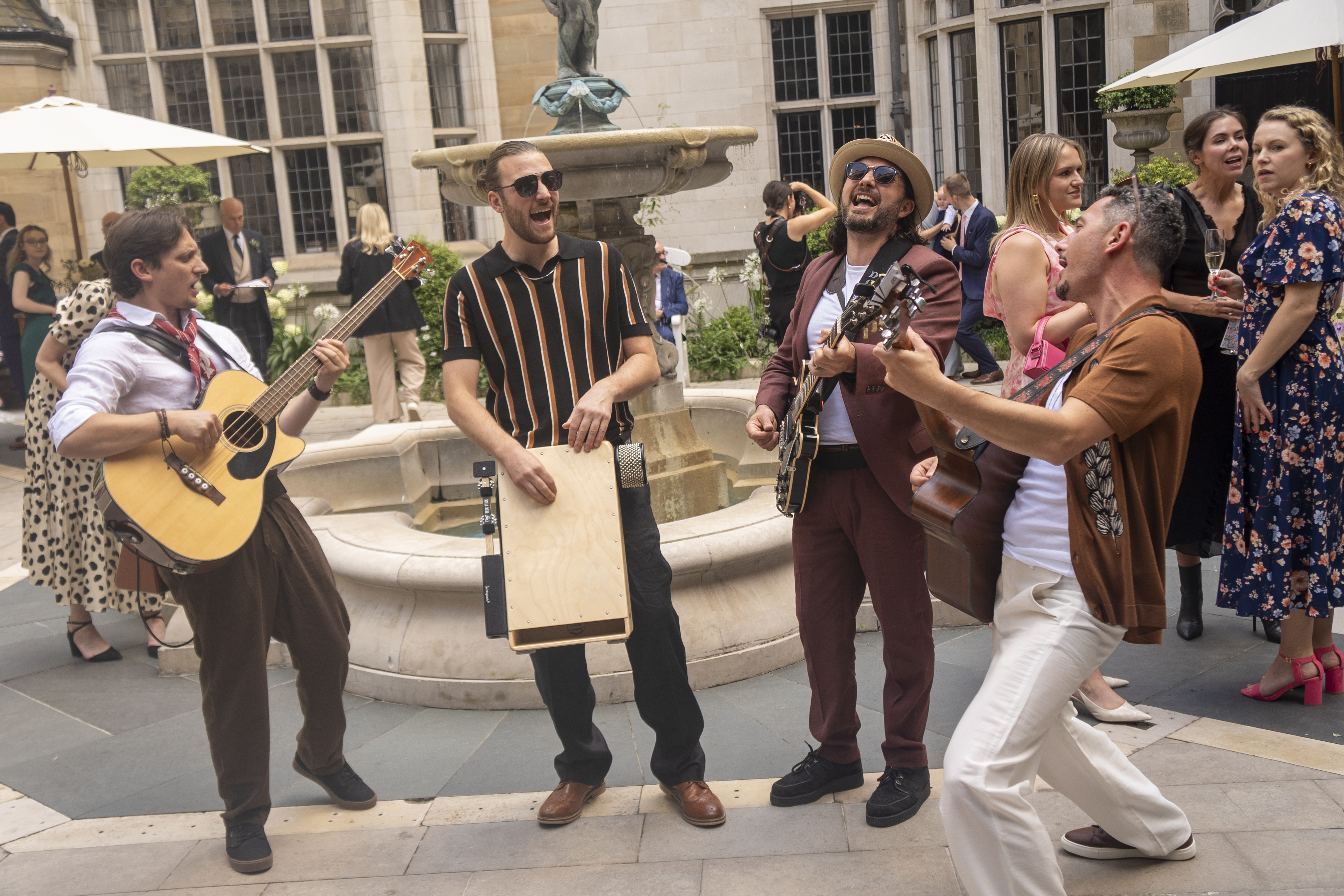 Four piece band The Flyways playing at a party in a courtyard with fountain