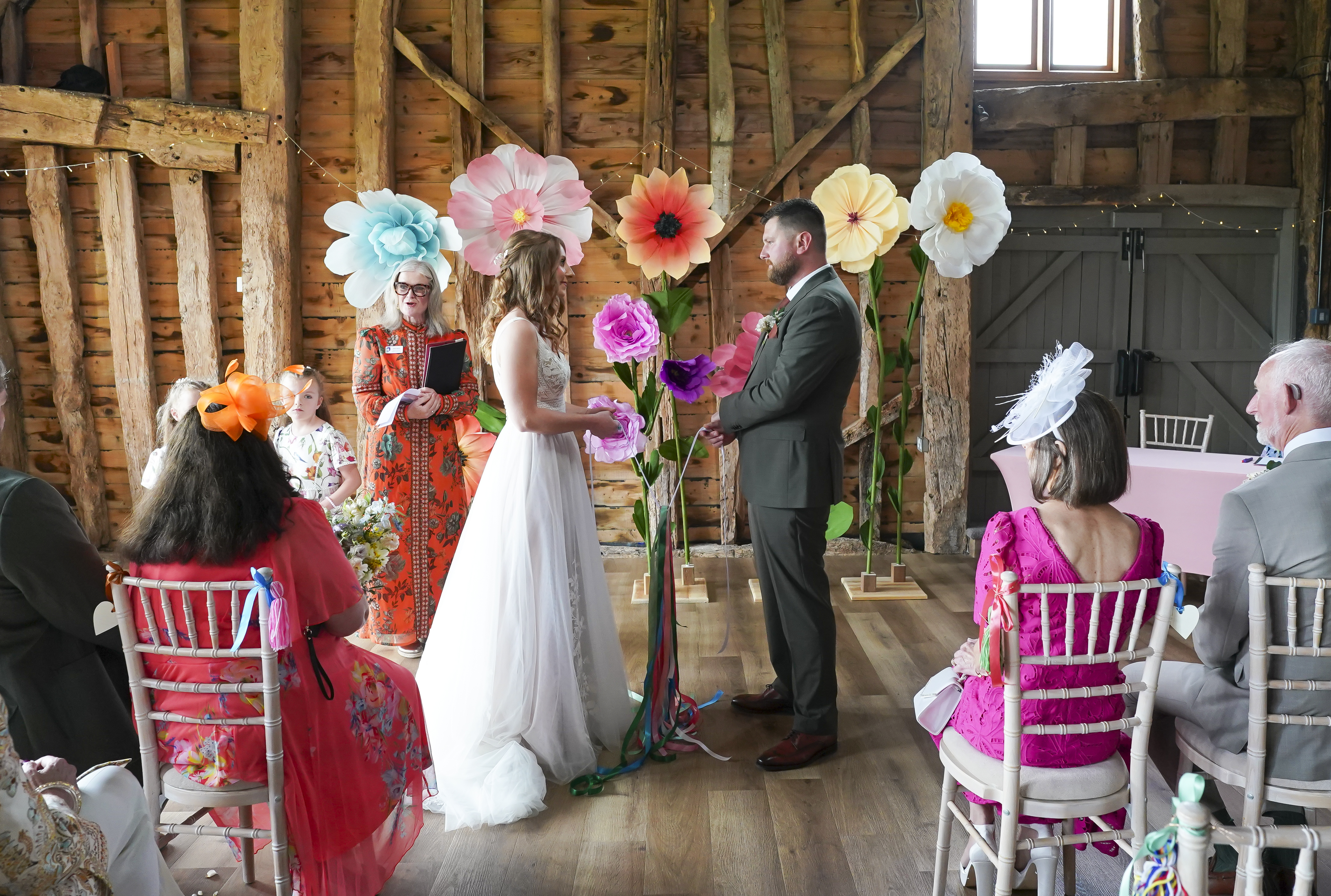 Couple holding colourful ribbons getting married in a tying the knot ceremony