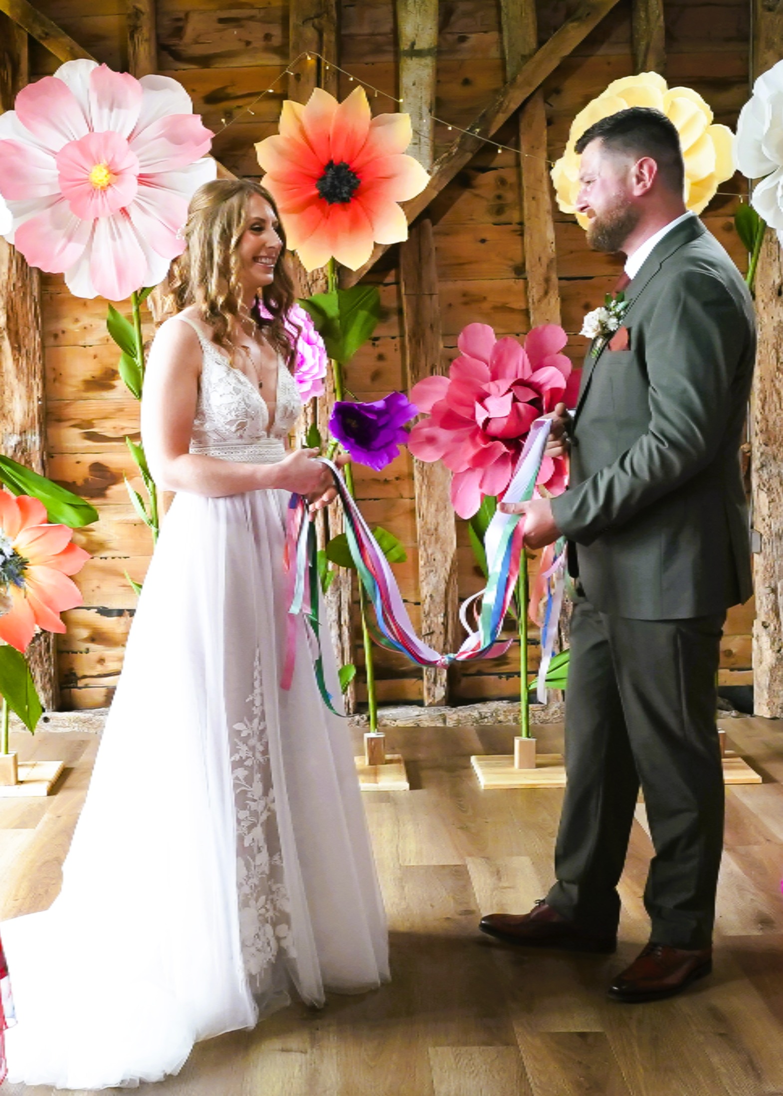 Bride and groom tying the knot with beautiful coloured ribbons