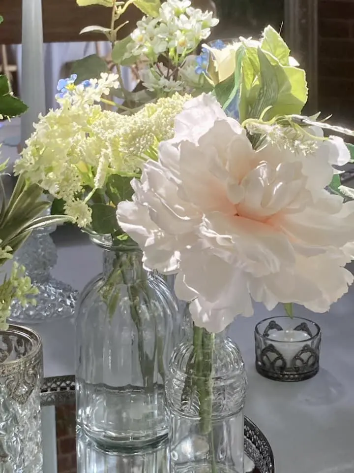 Beautiful pink peonie and other flowers in bridgerton inspired vases