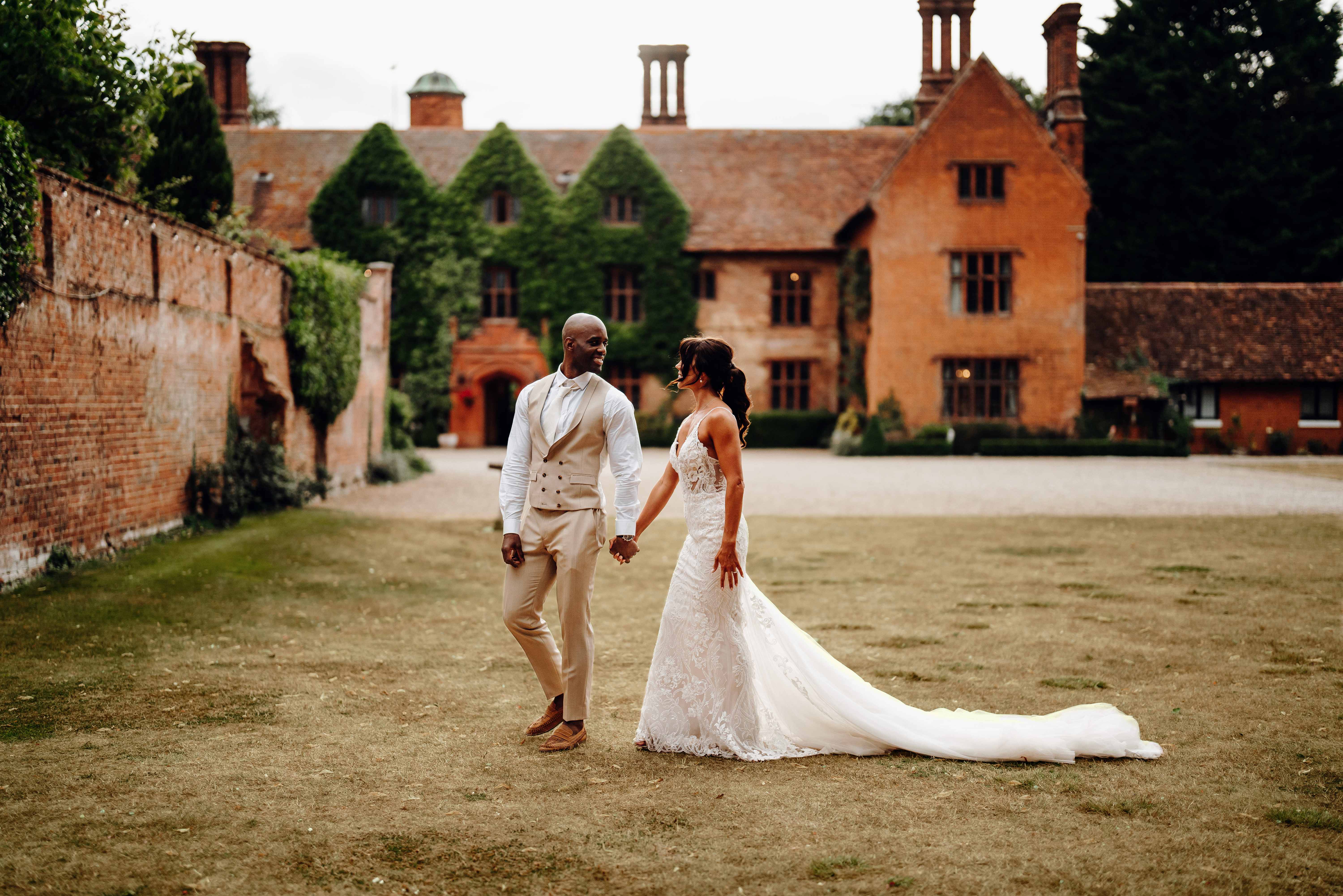 Mixed race couple walking and holding hands while smiling at each other
