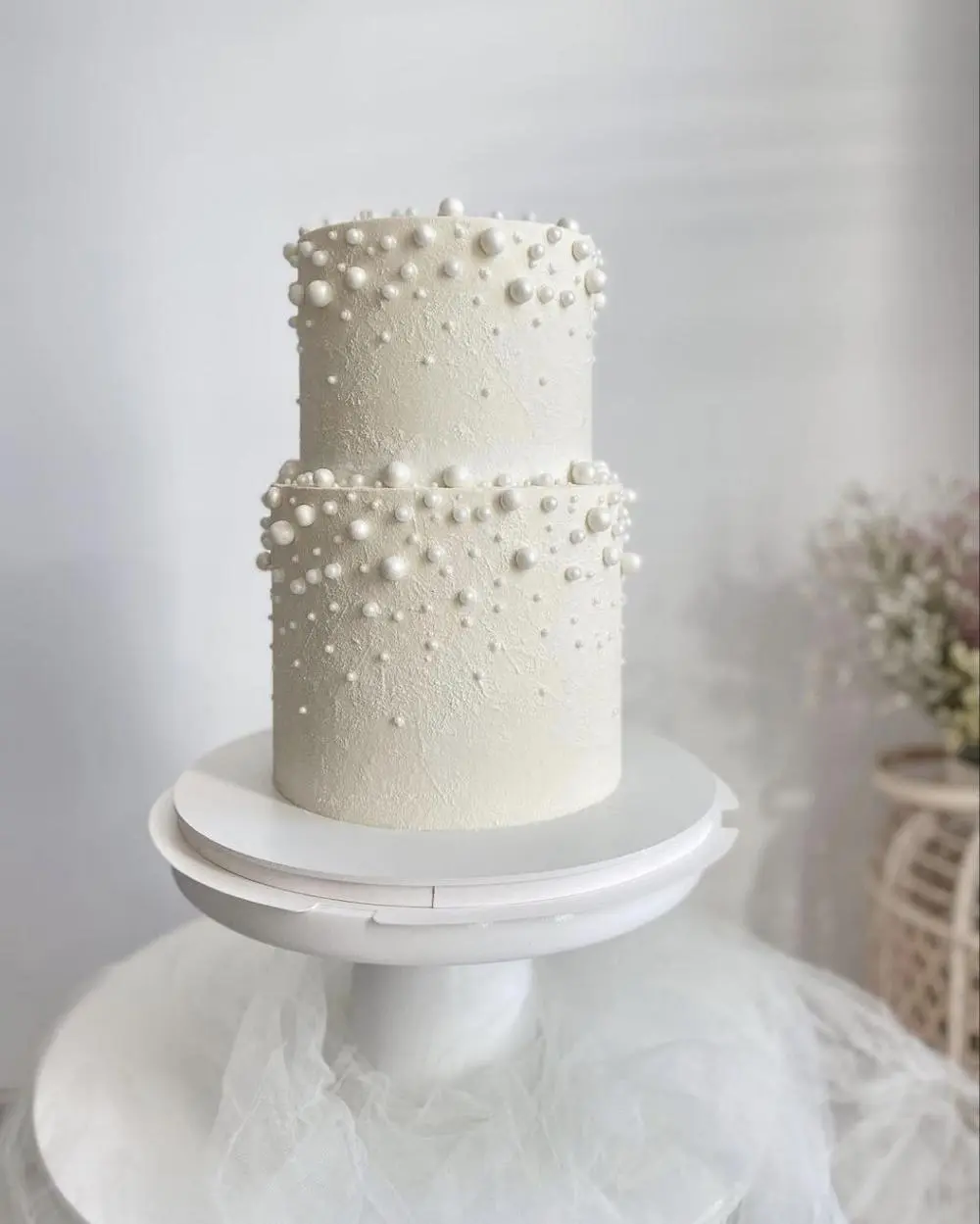 White two tier cake with baubles